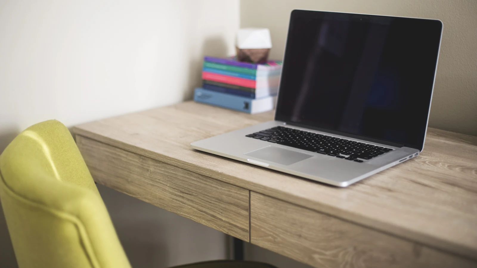 Photo of a solo operator working on a laptop at a home desk for an AI automation guide.
